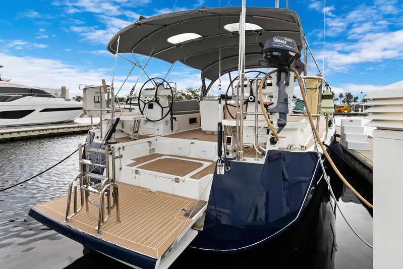 Beatrice Yacht Photos Pics 2021 Jeanneau Sun Odyssey 51 Performance yacht docked, featuring dual steering wheels and spacious deck.