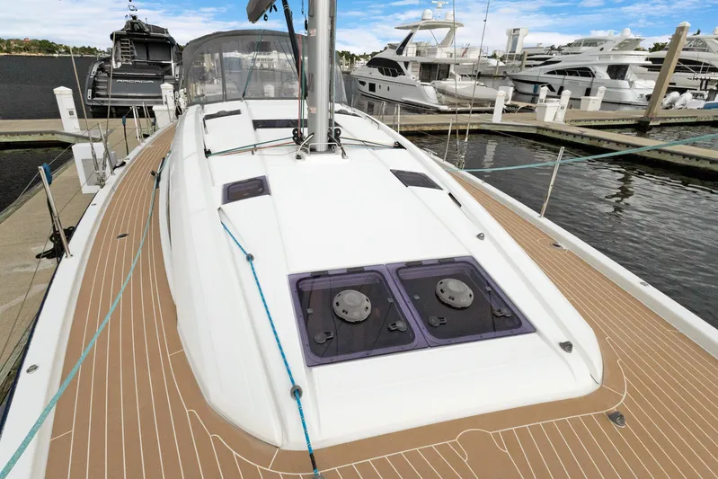 Beatrice Yacht Photos Pics 2021 Jeanneau Sun Odyssey 51 Performance yacht docked at marina, showcasing sleek deck design.