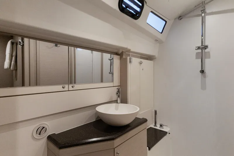 Beatrice Yacht Photos Pics Modern bathroom in 2021 Jeanneau Sun Odyssey 51 Performance yacht, featuring sleek sink and shower.