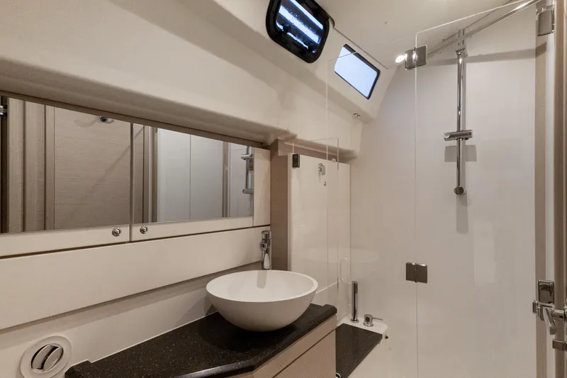 Beatrice Yacht Photos Pics Modern bathroom in 2021 Jeanneau Sun Odyssey 51 Performance yacht, featuring sleek design and fixtures.