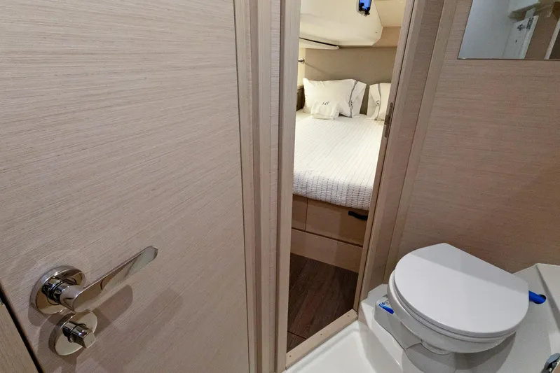 Beatrice Yacht Photos Pics Interior of 2021 Jeanneau Sun Odyssey 51 Performance yacht, featuring a cozy bedroom and bathroom.