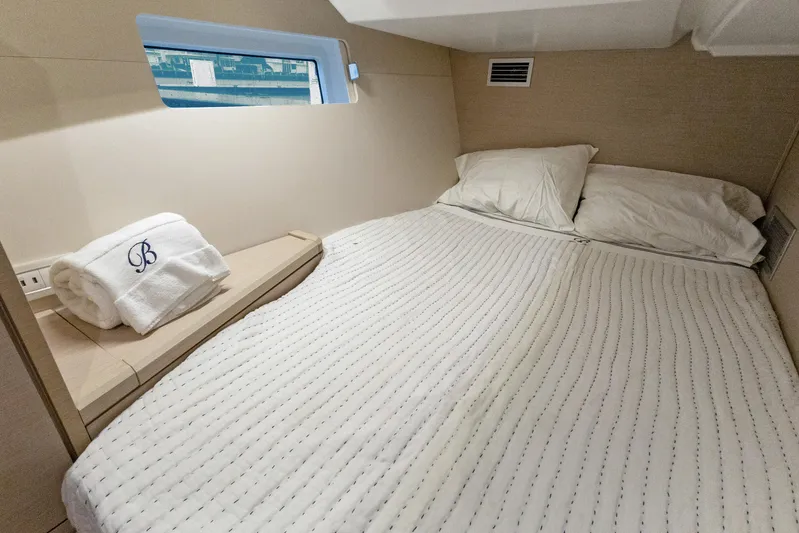 Beatrice Yacht Photos Pics Cozy cabin interior of 2021 Jeanneau Sun Odyssey 51 Performance yacht with neatly arranged bedding.