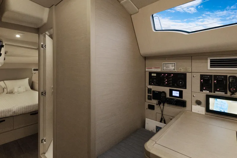 Beatrice Yacht Photos Pics Interior of 2021 Jeanneau Sun Odyssey 51 Performance yacht, featuring control panel and cozy cabin.