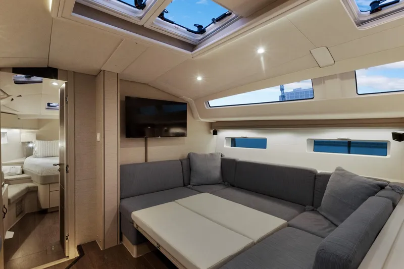 Beatrice Yacht Photos Pics Luxurious interior of 2021 Jeanneau Sun Odyssey 51 Performance yacht with modern seating and skylights.