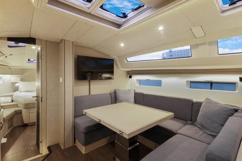 Beatrice Yacht Photos Pics Luxurious interior of 2021 Jeanneau Sun Odyssey 51 Performance yacht with modern seating and skylights.