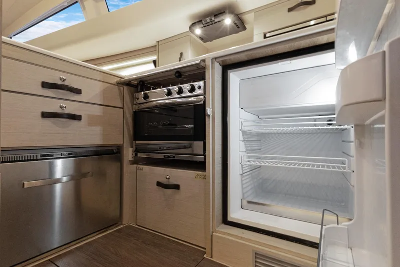 Beatrice Yacht Photos Pics Modern kitchen in 2021 Jeanneau Sun Odyssey 51 Performance yacht with open fridge and oven.