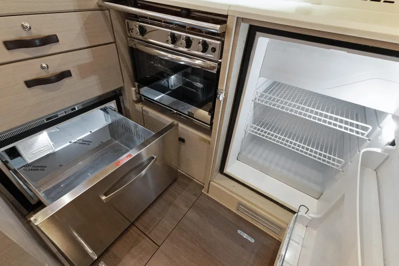 Beatrice Yacht Photos Pics Modern kitchen in Jeanneau Sun Odyssey 51 Performance yacht, featuring fridge and oven, 2021 model.