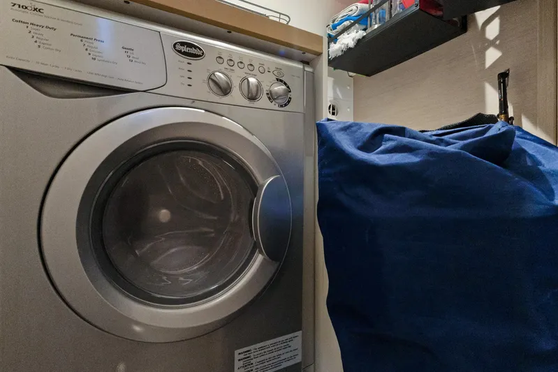 Beatrice Yacht Photos Pics Laundry area with a Splendide washing machine and a blue laundry bag.