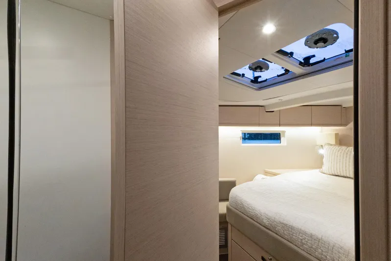 Beatrice Yacht Photos Pics Interior cabin of 2021 Jeanneau Sun Odyssey 51 Performance yacht, featuring a cozy bed and skylight.