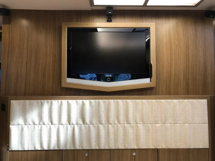  Yacht Photos Pics Flat-screen TV on wood-paneled wall in 2006 Riva Super Ego 68 yacht interior.