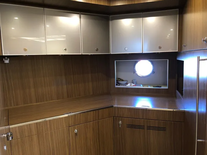  Yacht Photos Pics Luxurious wood-paneled interior of a 2006 Riva Super Ego 68 yacht kitchen.