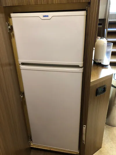  Yacht Photos Pics Built-in refrigerator on a 2006 Riva Super Ego 68 yacht, wooden cabinetry.