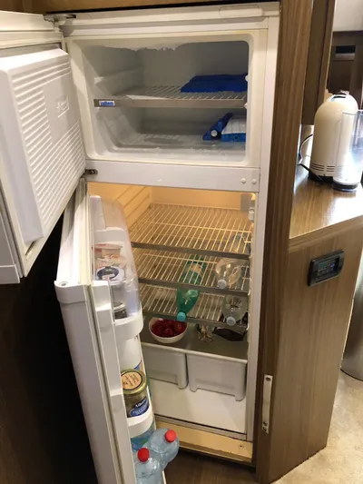  Yacht Photos Pics Open refrigerator in 2006 Riva Super Ego 68 yacht, stocked with drinks and food items.