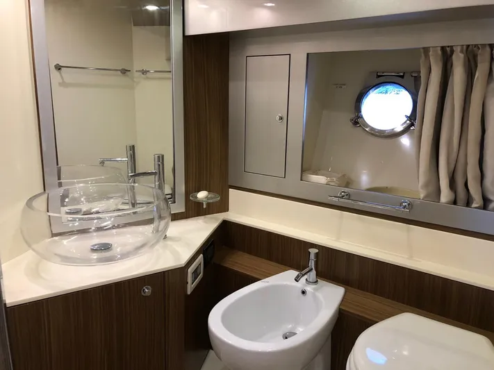  Yacht Photos Pics Luxurious bathroom in 2006 Riva Super Ego 68 yacht with modern fixtures and porthole window.