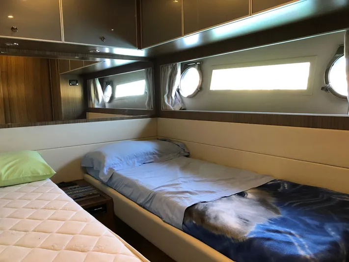  Yacht Photos Pics Interior cabin of 2006 Riva Super Ego 68 yacht with twin beds and porthole windows.