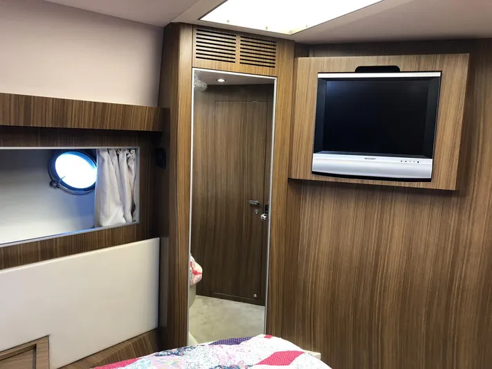  Yacht Photos Pics Interior of 2006 Riva Super Ego 68 yacht with wood paneling and mounted TV.