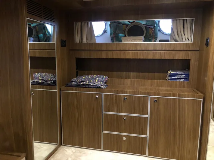  Yacht Photos Pics Interior of 2006 Riva Super Ego 68 yacht with wooden cabinetry and porthole window.