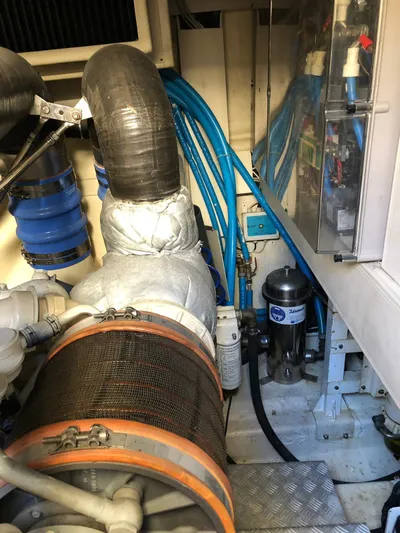  Yacht Photos Pics Engine room of a 2006 Riva Super Ego 68 yacht, showcasing mechanical components and piping.