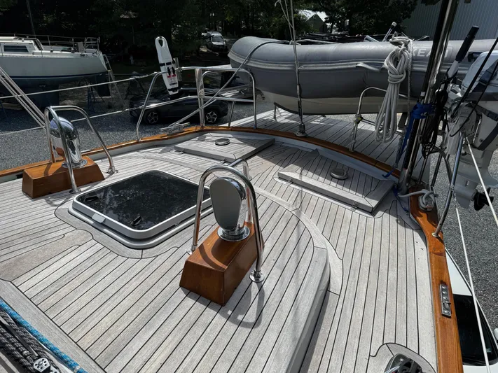 Pegasus Yacht Photos Pics Deck of 1984 Hallberg-Rassy 49 sailboat with dinghy and polished wood accents.