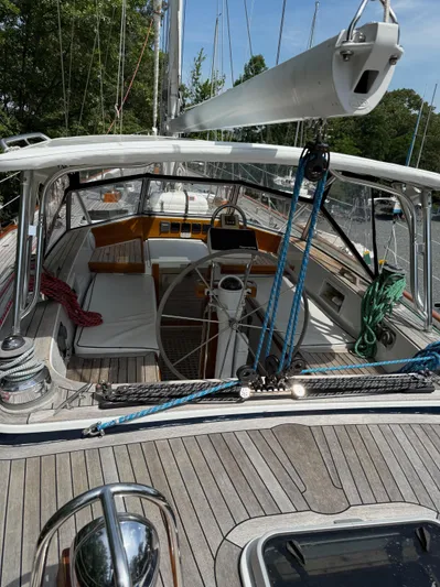 Pegasus Yacht Photos Pics 1984 Hallberg-Rassy 49 sailboat cockpit with wooden deck and steering wheel.