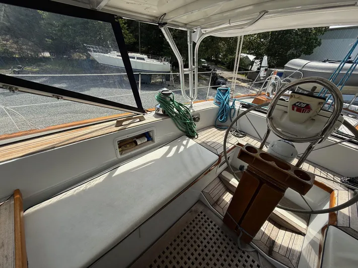 Pegasus Yacht Photos Pics 1984 Hallberg-Rassy 49 yacht cockpit with steering wheel and seating area.