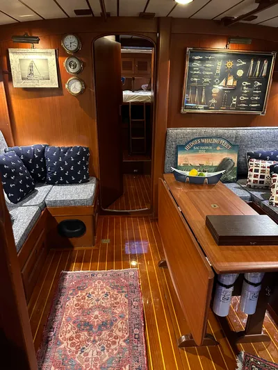 Pegasus Yacht Photos Pics Interior of 1984 Hallberg-Rassy 49 yacht with wooden decor and nautical accents.