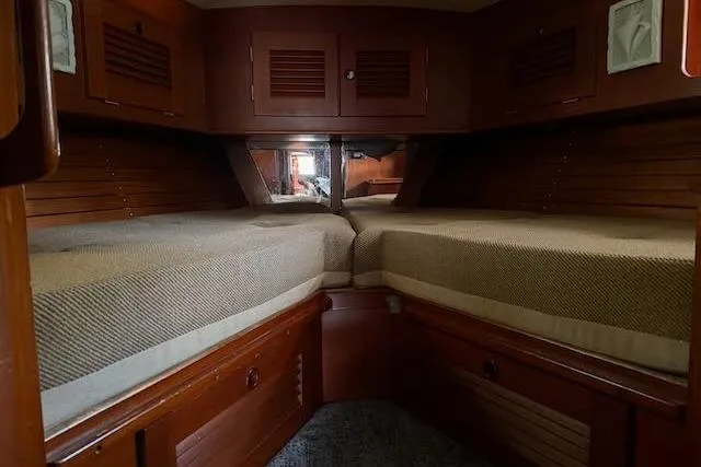 Pegasus Yacht Photos Pics 1984 Hallberg-Rassy 49 yacht cabin with twin beds and wooden interior.