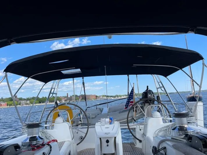 Rob Roy Yacht Photos Pics Cockpit view of 2008 Beneteau Oceanis 46 sailboat with canopy, docked by scenic waterfront.