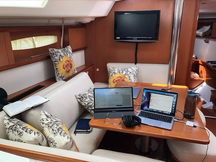 Rob Roy Yacht Photos Pics Interior of 2008 Beneteau Oceanis 46 yacht with laptops and cozy seating area.