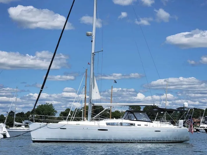 Rob Roy Yacht Photos Pics 2008 Beneteau Oceanis 46 sailboat on calm water under a blue sky with clouds.