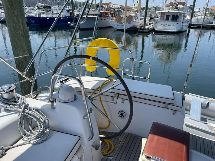 Rob Roy Yacht Photos Pics Cockpit of 2008 Beneteau Oceanis 46 sailboat with steering wheel and marina view.