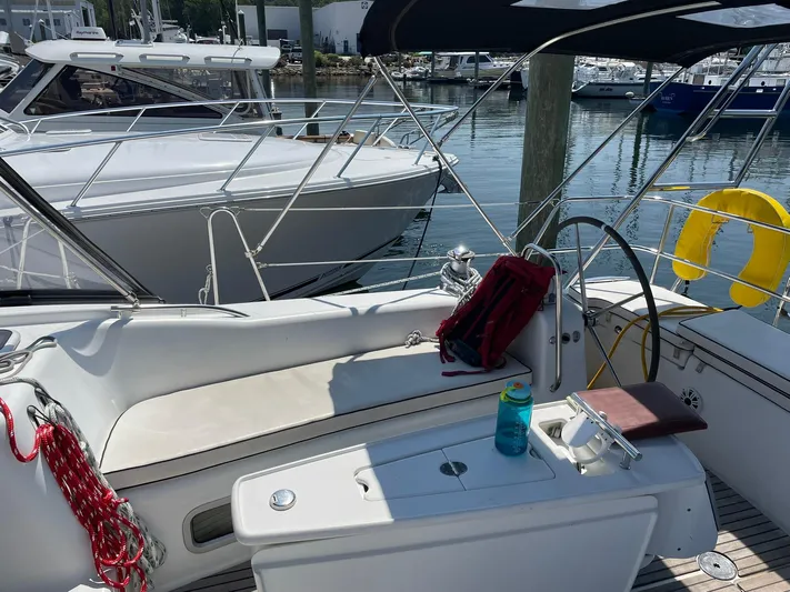 Rob Roy Yacht Photos Pics Beneteau Oceanis 46 sailboat cockpit with seating, steering wheel, and marina view.