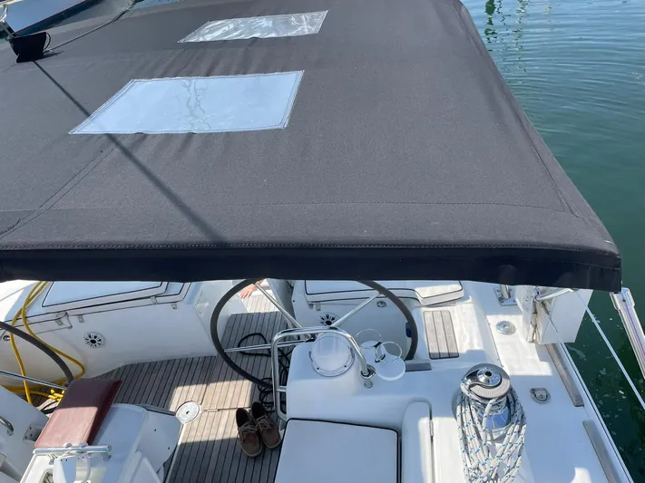 Rob Roy Yacht Photos Pics Beneteau Oceanis 46 cockpit with black canopy, steering wheel, and deck details, 2008 model.