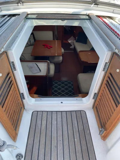 Rob Roy Yacht Photos Pics Interior view of 2008 Beneteau Oceanis 46 sailboat, featuring cozy seating and wooden accents.