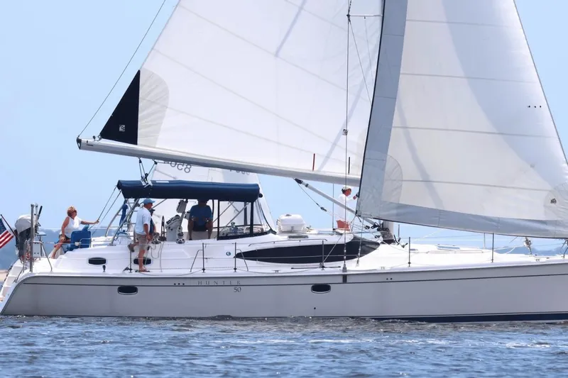  Yacht Photos Pics 2009 Hunter 50 Center Cockpit sailboat cruising on open water with crew onboard.
