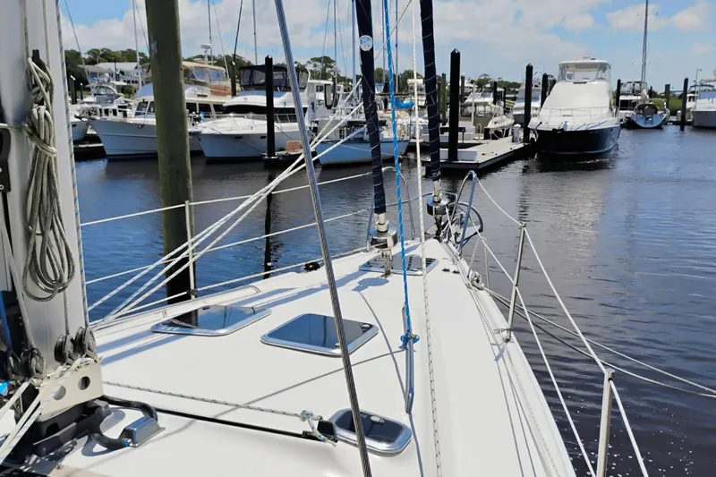  Yacht Photos Pics 2009 Hunter 50 Center Cockpit sailboat docked in a marina, surrounded by other boats.