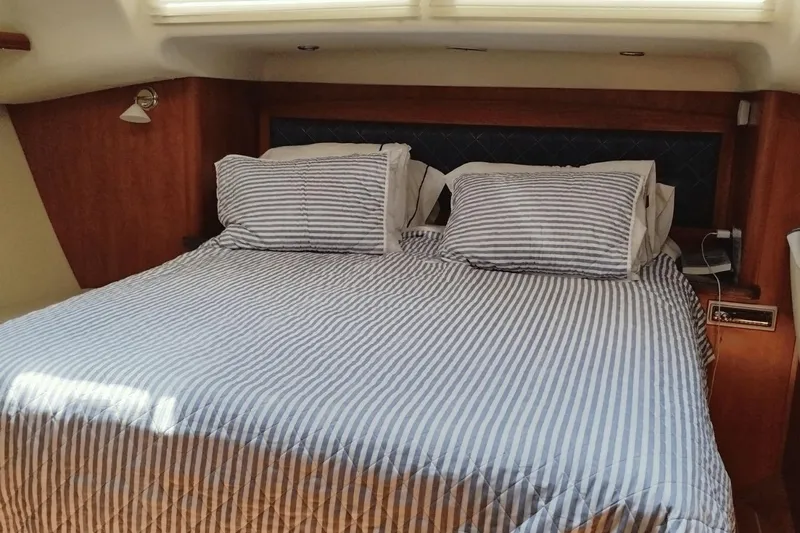  Yacht Photos Pics Cozy cabin bedroom in 2009 Hunter 50 Center Cockpit yacht with striped bedding.