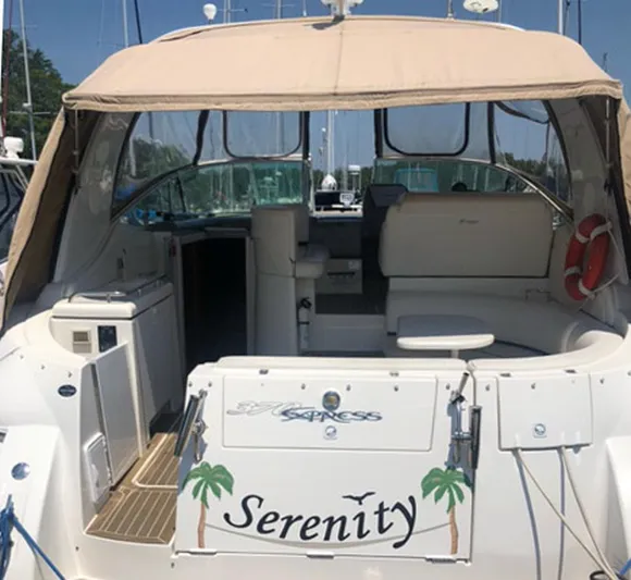 Serenity Yacht Photos Pics 2007 Cruisers Yachts 370 Express boat named "Serenity" with tan canopy and seating area.