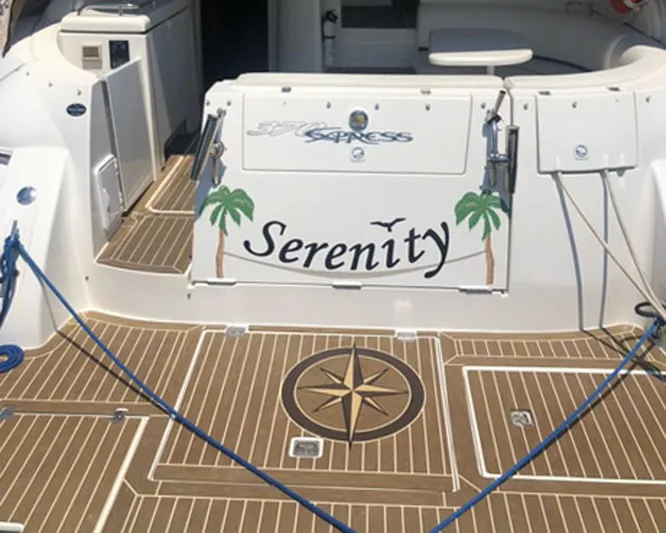 Serenity Yacht Photos Pics 2007 Cruisers Yachts 370 Express boat deck with "Serenity" name and palm tree design.