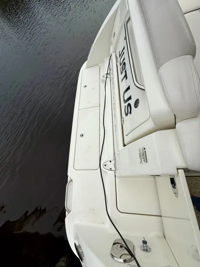 Just Us Yacht Photos Pics 2010 Sea Ray 310 Sundancer boat with "Just Us" on the stern, docked by water.