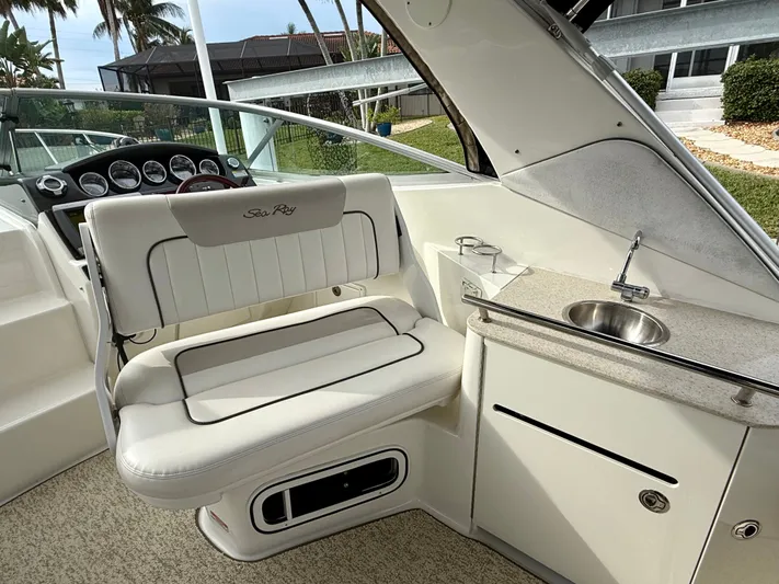 Just Us Yacht Photos Pics 2010 Sea Ray 310 Sundancer interior with helm, seating, and sink.