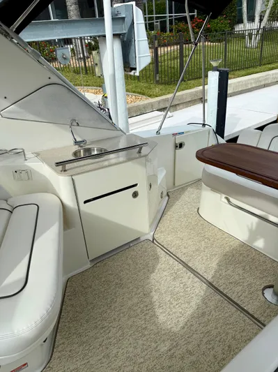 Just Us Yacht Photos Pics 2010 Sea Ray 310 Sundancer interior with seating, sink, and table.