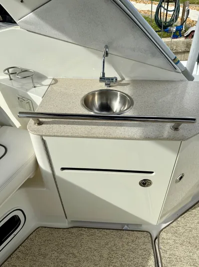 Just Us Yacht Photos Pics 2010 Sea Ray 310 Sundancer boat kitchenette with sink and countertop.