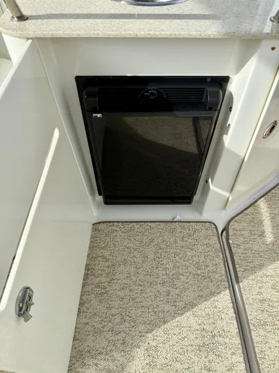 Just Us Yacht Photos Pics 2010 Sea Ray 310 Sundancer interior with compact fridge and carpeted flooring.