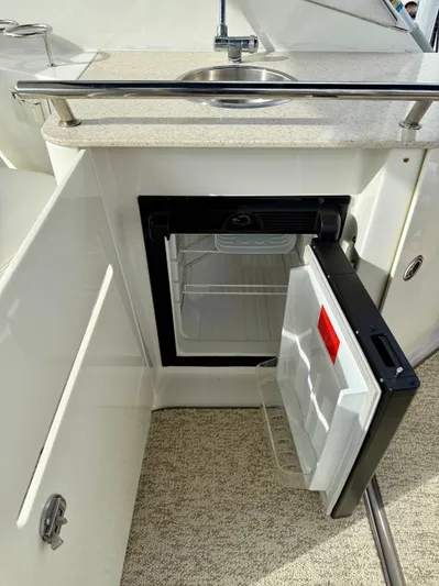 Just Us Yacht Photos Pics Open mini fridge and sink on 2010 Sea Ray 310 Sundancer boat.