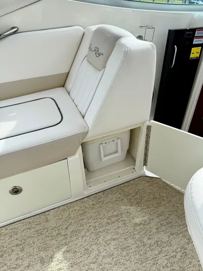 Just Us Yacht Photos Pics 2010 Sea Ray 310 Sundancer interior with white seating and open storage compartment.
