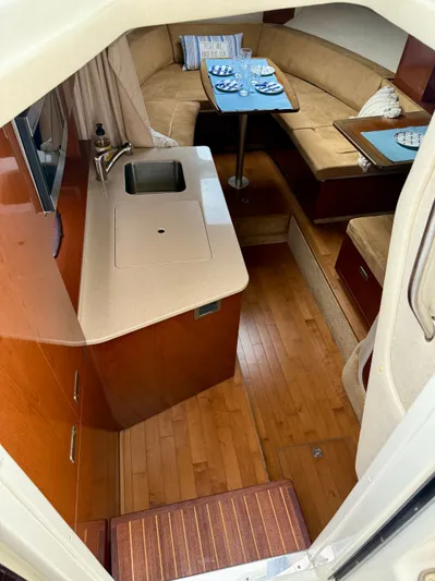 Just Us Yacht Photos Pics Interior of 2010 Sea Ray 310 Sundancer with kitchenette and dining area.