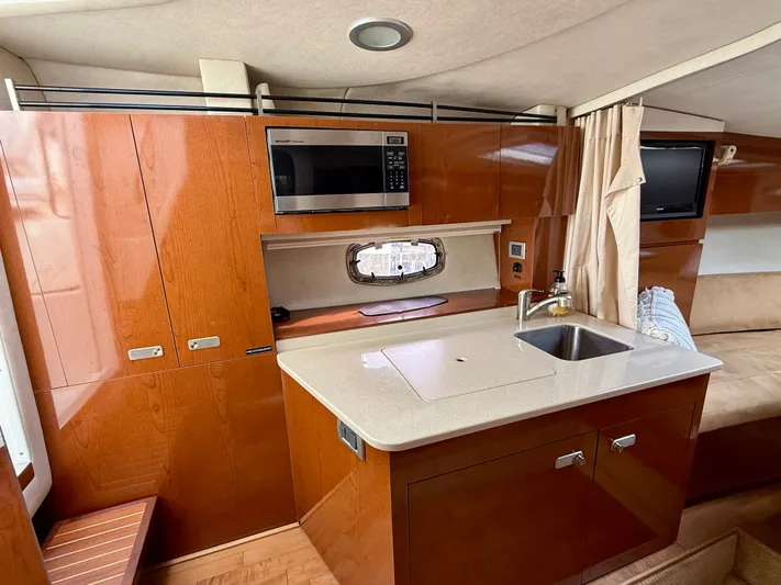 Just Us Yacht Photos Pics Interior of 2010 Sea Ray 310 Sundancer yacht with kitchenette and modern amenities.