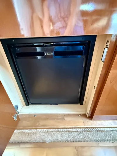 Just Us Yacht Photos Pics Compact Dometic refrigerator inside 2010 Sea Ray 310 Sundancer yacht cabin.