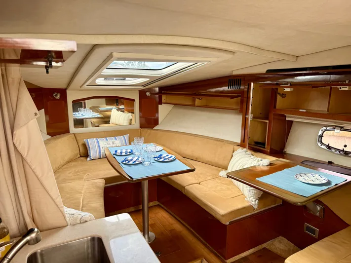 Just Us Yacht Photos Pics Luxurious interior of 2010 Sea Ray 310 Sundancer yacht with cozy seating and dining area.